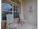 Relaxing front porch featuring comfortable white chairs, perfect for enjoying quiet moments outdoors at 3001 Lake Huron Ln, Tavares, FL 32778