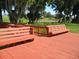 Scenic view of a wooden deck with multiple benches providing a peaceful spot to enjoy the waterfront at 3001 Lake Huron Ln, Tavares, FL 32778