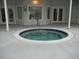 This round hot tub features tile and steps for easy access near the exterior of the community clubhouse at 3001 Lake Huron Ln, Tavares, FL 32778
