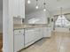 Bright kitchen featuring white cabinets, tiled flooring, and modern lighting at 3001 Lake Huron Ln, Tavares, FL 32778