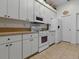 Well-equipped kitchen with white appliances and cabinetry, offering ample storage space at 3001 Lake Huron Ln, Tavares, FL 32778