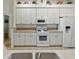 Bright kitchen featuring white cabinets and appliances for a modern look at 3001 Lake Huron Ln, Tavares, FL 32778
