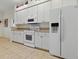 Clean kitchen with white cabinets and appliances, offering a bright space at 3001 Lake Huron Ln, Tavares, FL 32778
