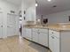 Functional kitchen space featuring a dishwasher, ample counter space, and convenient layout at 3001 Lake Huron Ln, Tavares, FL 32778
