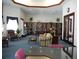 Bright and spacious library with extensive bookshelves, comfortable seating, and ample lighting at 3001 Lake Huron Ln, Tavares, FL 32778