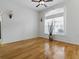 Hardwood floors enhance this airy living room with a large window and stylish ceiling fan at 3001 Lake Huron Ln, Tavares, FL 32778