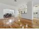 Expansive living room with hardwood floors, archways to dining and kitchen, and an open concept layout at 3001 Lake Huron Ln, Tavares, FL 32778