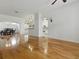 Spacious living room featuring gleaming hardwood floors, open layout, and seamless flow to the dining and kitchen areas at 3001 Lake Huron Ln, Tavares, FL 32778