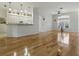 Open-concept living area with wood floors, ceiling fan, and natural light at 3001 Lake Huron Ln, Tavares, FL 32778
