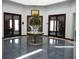 Bright lobby featuring a marble table, elegant floral arrangement, and double doors leading to various rooms in the clubhouse at 3001 Lake Huron Ln, Tavares, FL 32778