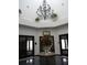 The clubhouse lobby showcases an ornate chandelier, a floral centerpiece on a marble table, and elegant doorways at 3001 Lake Huron Ln, Tavares, FL 32778