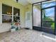 Enclosed lanai featuring tile flooring and lovely views of the landscaped backyard at 3001 Lake Huron Ln, Tavares, FL 32778