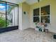 Enclosed patio with tiled floors and serene views of the home's lush and colorful landscaping at 3001 Lake Huron Ln, Tavares, FL 32778