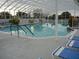 Inviting community pool area with ample seating, clear water, and a covered structure, perfect for relaxation and recreation at 3001 Lake Huron Ln, Tavares, FL 32778