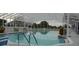Bright enclosed pool features clear water, white frame structure, and ample seating for resident relaxation at 3001 Lake Huron Ln, Tavares, FL 32778