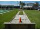 Shuffleboard court with covered seating provides a space for relaxation and recreation among meticulously maintained landscaping at 3001 Lake Huron Ln, Tavares, FL 32778