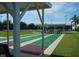 Enjoy leisure time on the shuffleboard court, shaded by a pavilion amidst lush green surroundings and blue skies at 3001 Lake Huron Ln, Tavares, FL 32778