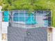 Aerial view of private screened pool, sunshades, patio furniture, and manicured landscaping at 310 Ballyshannon Dr, Davenport, FL 33897