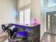 Contemporary bar area with ledges with black stone, chrome accents, and high chairs at 310 Ballyshannon Dr, Davenport, FL 33897