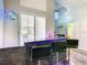 Stylish bar area features modern black tile, seating, and unique blue neon lighting at 310 Ballyshannon Dr, Davenport, FL 33897