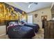 The bedroom has a ceiling fan and a large accent wall at 310 Ballyshannon Dr, Davenport, FL 33897