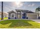 Charming single-Gathering home with a well-manicured lawn and a modern exterior design at 310 Ballyshannon Dr, Davenport, FL 33897