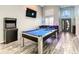 Open game room featuring a pool table, bar area, and arcade game for entertaining guests at 310 Ballyshannon Dr, Davenport, FL 33897