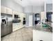 Bright kitchen featuring granite counters, stainless steel appliances, tile floors, and ample cabinet space at 310 Ballyshannon Dr, Davenport, FL 33897