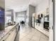 Open-concept kitchen with granite countertops, stainless steel appliances, and tile flooring at 310 Ballyshannon Dr, Davenport, FL 33897