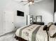 Light-filled main bedroom featuring a ceiling fan, ensuite bathroom, and plush carpeting at 310 Ballyshannon Dr, Davenport, FL 33897