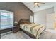 Bright main bedroom featuring a ceiling fan, ensuite bathroom, and large windows for natural light at 310 Ballyshannon Dr, Davenport, FL 33897