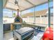 Well-equipped outdoor kitchen featuring a pizza oven and granite countertops, great for entertaining at 310 Ballyshannon Dr, Davenport, FL 33897
