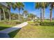 Inviting community path with shady palm trees and benches for relaxing and enjoying the scenery at 310 Ballyshannon Dr, Davenport, FL 33897