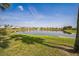 Beautiful pond view with lush green surroundings and charming homes in the background at 310 Ballyshannon Dr, Davenport, FL 33897