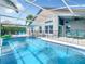 Sparkling screened-in pool area, fenced in for safety, complemented by an outdoor seating and lounge area at 310 Ballyshannon Dr, Davenport, FL 33897