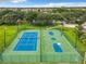 Community tennis and basketball courts surrounded by lush landscaping, perfect for an active lifestyle at 310 Ballyshannon Dr, Davenport, FL 33897
