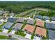 An aerial shot of homes in the community, showcasing the pond and wooded area beyond at 3138 Aurea Pl, The Villages, FL 32163