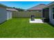 A lush backyard with a well-manicured lawn, a barbecue, a patio, and a privacy fence at 3138 Aurea Pl, The Villages, FL 32163