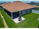 A well-maintained backyard featuring a screened lanai and patio with a grill for outdoor enjoyment at 3138 Aurea Pl, The Villages, FL 32163