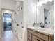 Bathroom with marble countertops and view to the hall and bedroom offering a view of the house at 3138 Aurea Pl, The Villages, FL 32163