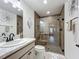 Modern bathroom featuring sleek fixtures, bright lighting, and glass enclosed shower with wood look tile at 3138 Aurea Pl, The Villages, FL 32163