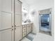 Stylish bathroom features a spacious vanity and access to both the bedroom and the shower room at 3138 Aurea Pl, The Villages, FL 32163