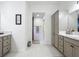A modern bathroom features a vanity with marble countertops and ample storage at 3138 Aurea Pl, The Villages, FL 32163
