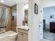Bathroom with wood-look tile shower, sleek fixtures, and marble countertop vanity in neutral, calming colors at 3138 Aurea Pl, The Villages, FL 32163