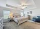 This bedroom boasts tray ceilings, a ceiling fan, and stylish furnishings, bathed in natural light at 3138 Aurea Pl, The Villages, FL 32163