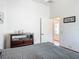 Bedroom with modern decor, neutral colors, and a view to an adjacent tiled entry at 3138 Aurea Pl, The Villages, FL 32163