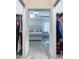 View of a bedroom through walk-in closets filled with clothing and shoe racks at 3138 Aurea Pl, The Villages, FL 32163