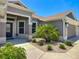 Front exterior of home with desert landscaping, gray paint, and a three-car garage at 3138 Aurea Pl, The Villages, FL 32163