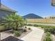 A beautifully landscaped front yard with lush plantings and a sidewalk leading to the house at 3138 Aurea Pl, The Villages, FL 32163