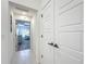 Bright hallway with white doors leads to a bedroom with neutral decor and ample natural light at 3138 Aurea Pl, The Villages, FL 32163